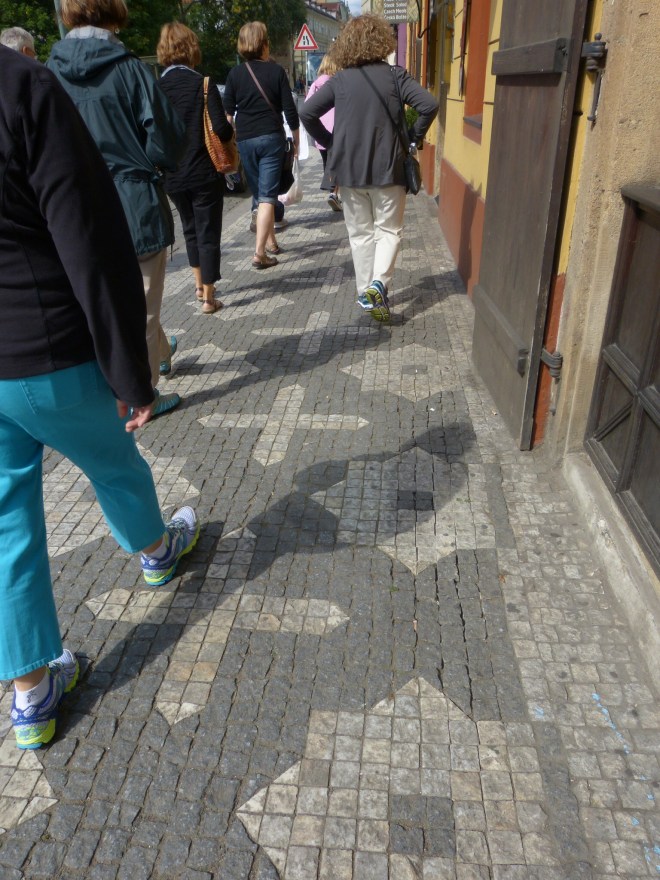 I was also looking DOWN, at the wonderful sidewalks. That looks to me like the Star of David and a cross, peacefully sharing space on the sidewalk.  