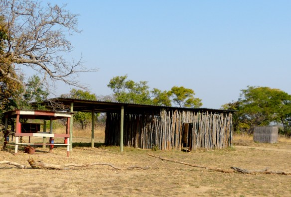 The bathroom is the smaller structure on the far right.