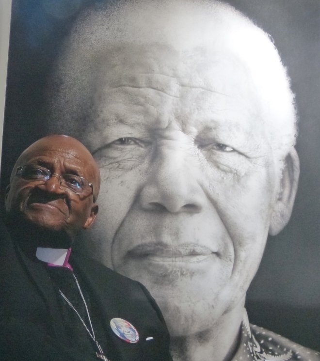Tutu in front of a photo of Mandela, at St. George's Cathedral. Cape Town.