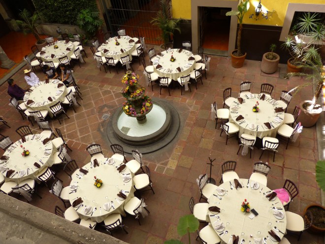 The "birthday boy" is wearing a white hat, and waiting for his guests to arrive.